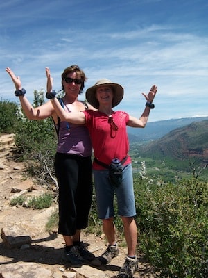 Two hikers celebrating on a mountain overlook
