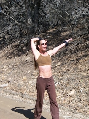 Woman stretching outdoors on a trail