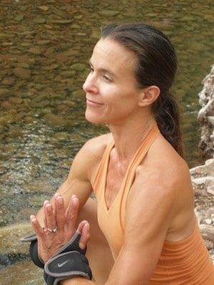 Hikercise yoga pose by the water